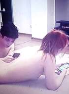 Young couple watching porn movies at home naked